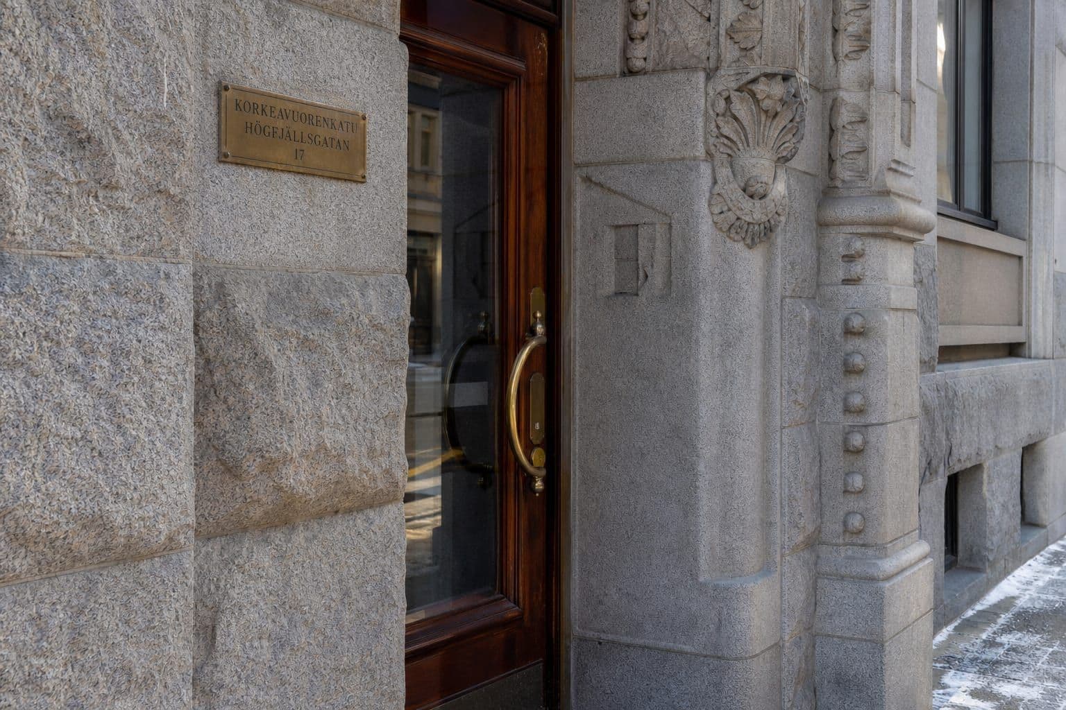 Helsinki stone and brass — where the office was formalised